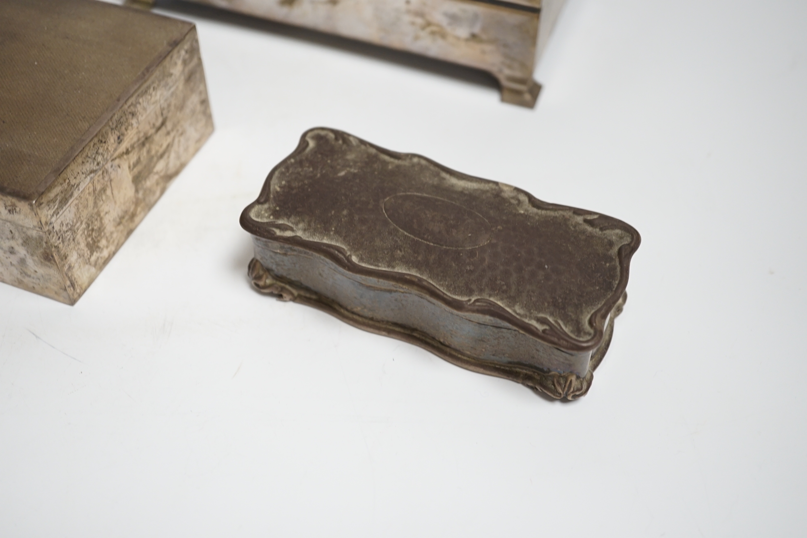 Two engine turned silver mounted cigarette boxes, the largest by Garrard & Co, London, 1955, 16.9cm and a silver trinket box.